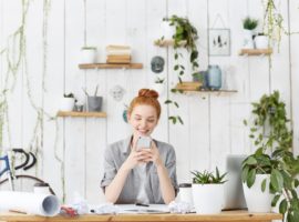 attractive-young-european-female-architect-wearing-her-ginger-hair-bun-sitting-her-workspace_273609-14137